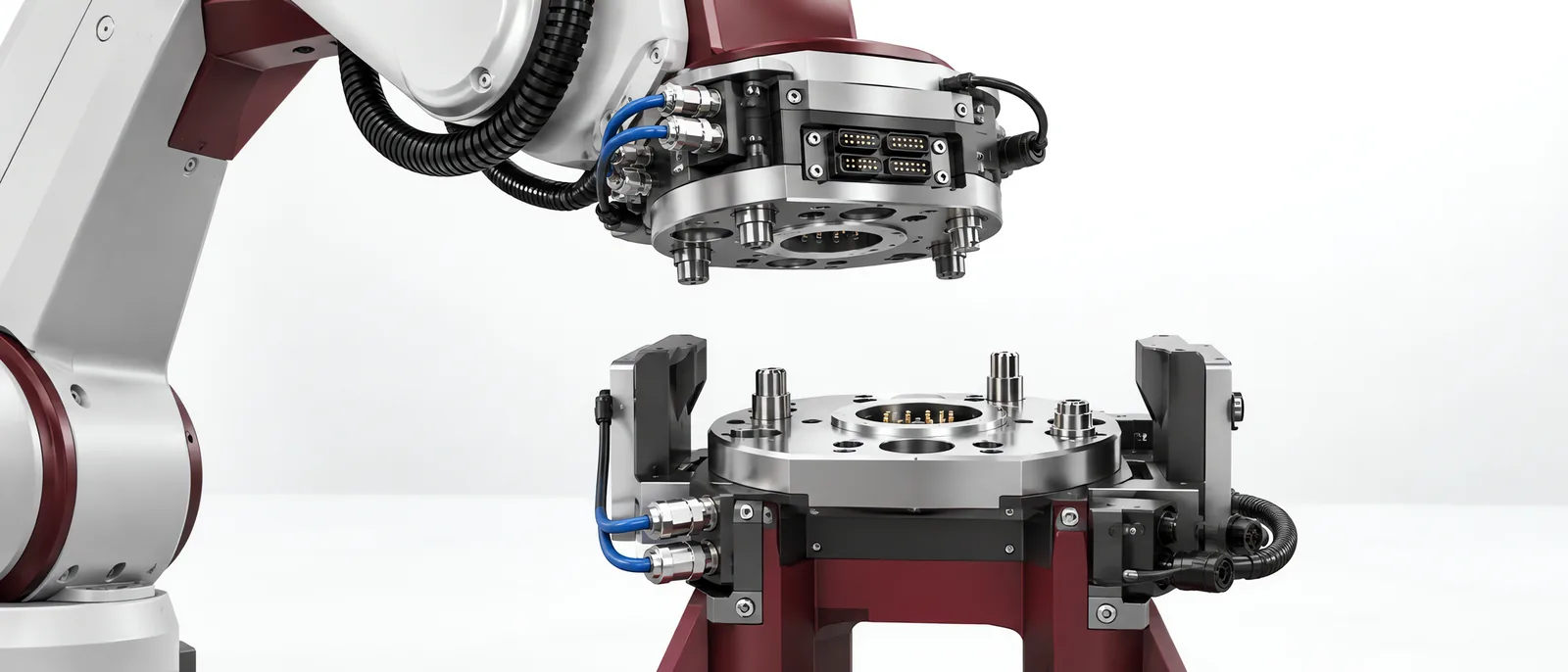 Robot wrist coupling above a docked interchangeable tool, conceptual illustration