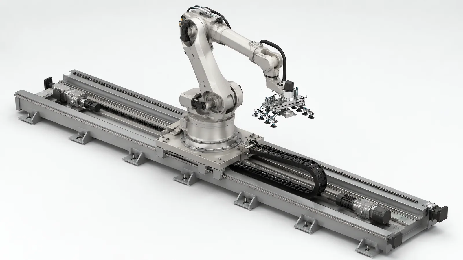 Heavy-duty robot rail: a deep welded steel beam on bolted floor plates, a large carriage on wide linear guides carrying a six-axis robot, rack and pinion drive with a gearmotor at each end, a thick energy chain in a steel trough and buffer stops at the rail ends