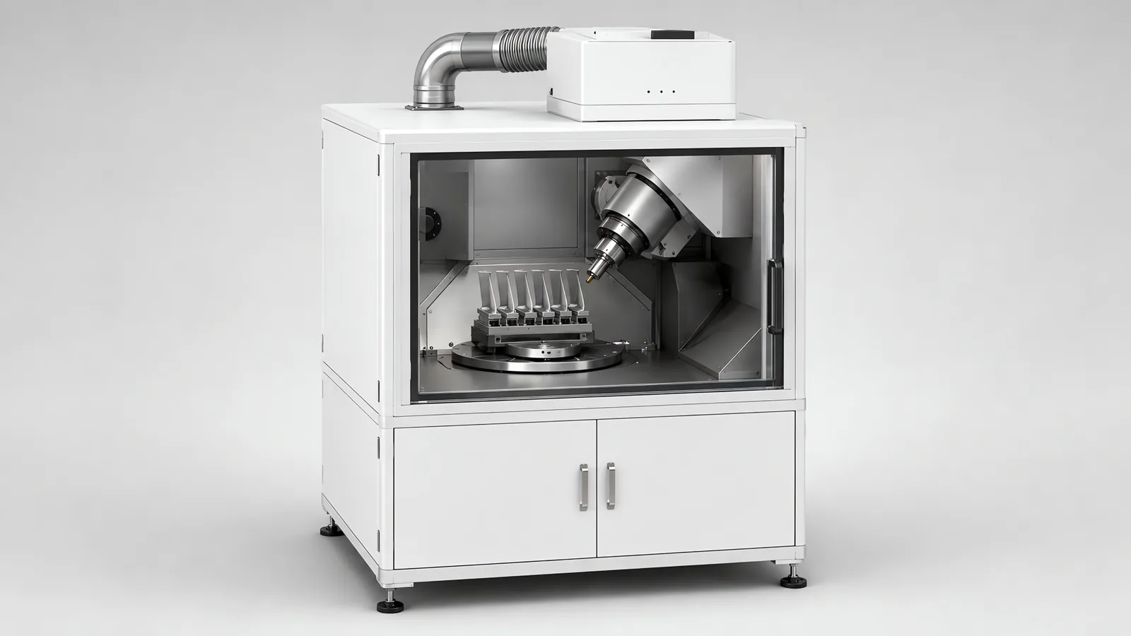 Five-axis shot peening machine: an enclosed cabinet with a viewing window, inside a nozzle on a tilting and rotating head aimed at turbine blades held in a comb rack on a rotary table, a media hopper below and extraction ducting leaving the roof