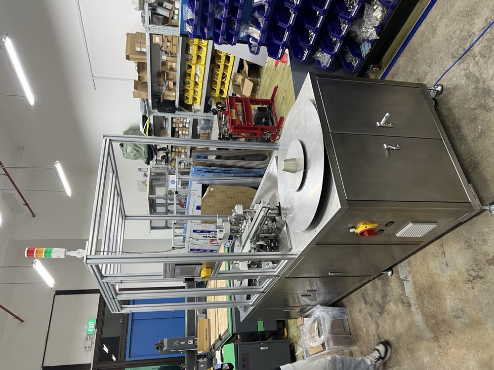 Physical installation of food-grade filling and sealing machine with stainless steel frame and safety guarding